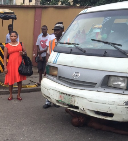 Bus Driver Lies Under His bus  as VIO Officials Try To Impound His Car 
