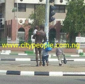 Unclad Man Roaming The Streets Of Abuja With His Kids All Dressed Up (Photo) 2614812_maninabuja_jpeg0619a3998d0a5fc14d1b1bbe66bd2e45