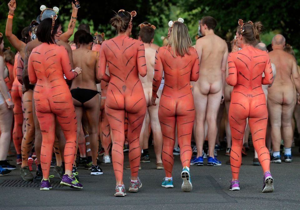 Participants painted their nude bodies in fitting tiger stripes and prowled...