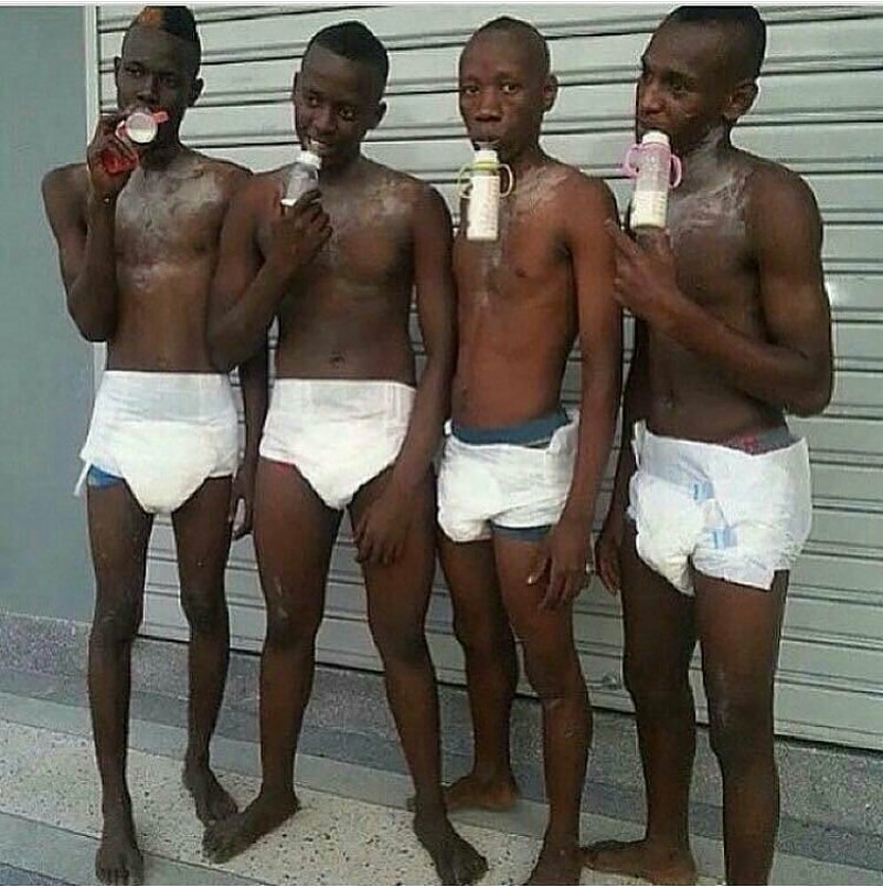 Shocking Pic Of Unclad Men Wearing Diapers & Drinking From Feeding