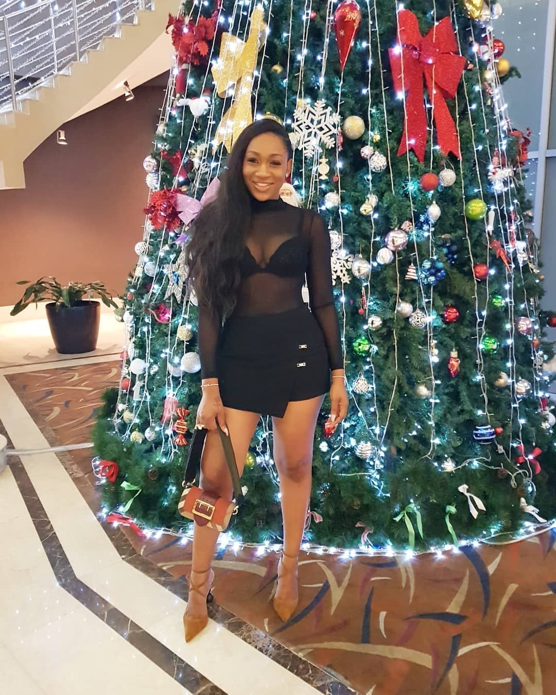 Ebube Nwagbo Rocks Transparent Outfit As She Strikes A Pose With Christmas Tree